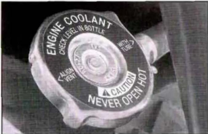 ENGINE COOLANT CHECK LEVEL IN BOTTLE WITH TURG CALISON VENT A CAUTION NEVER OPEN HOT