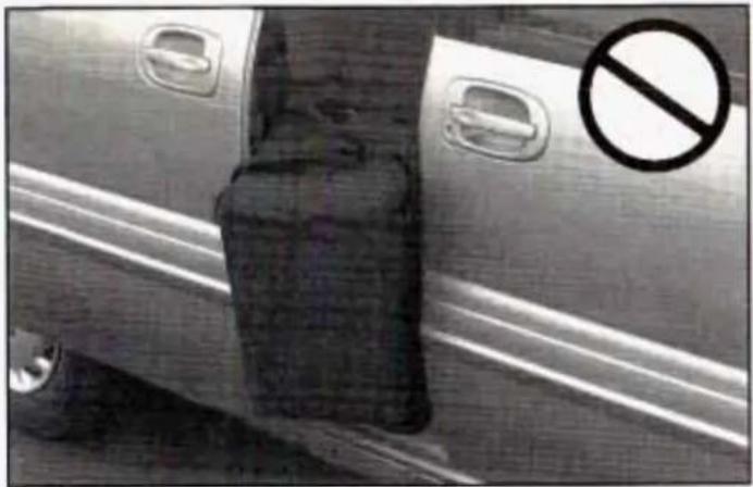 Exterior view of a car with a suitcase and a no-smoking symbol (no text or numbers on the car itself)