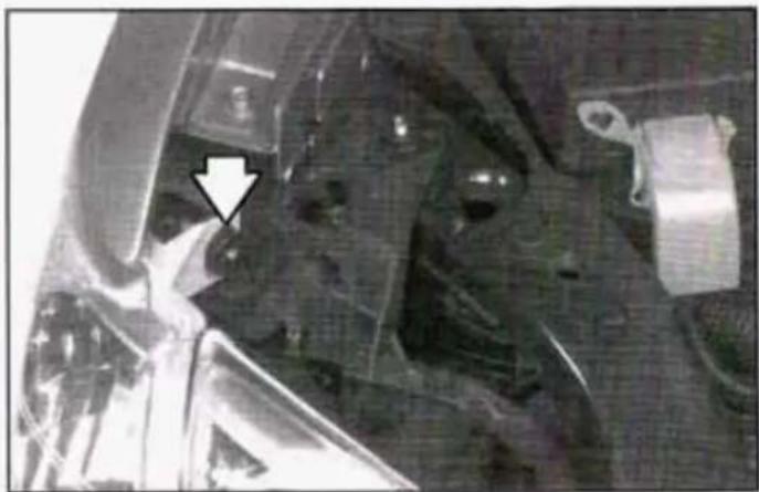 Close-up of mechanical components with a white arrow pointing to a specific part (no visible text or symbols)