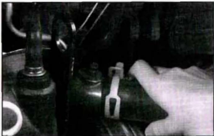Close-up of a hand operating a mechanical component with no visible text or symbols
