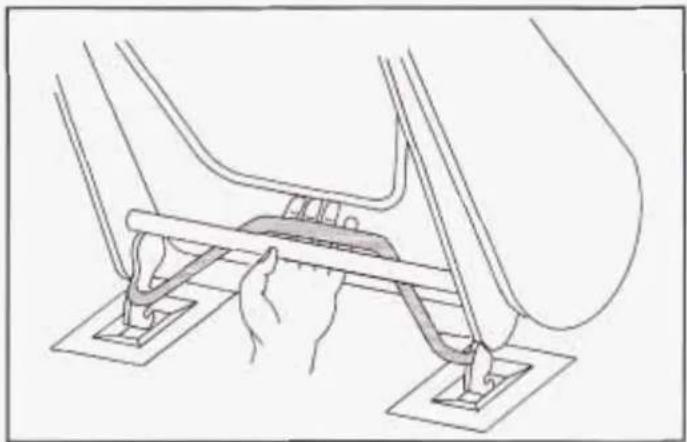 Line drawing of a mechanical assembly with hands operating a bracket (no text or symbols)