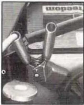 Close-up of mechanical components with metallic rods and a circular base (no visible text or symbols)