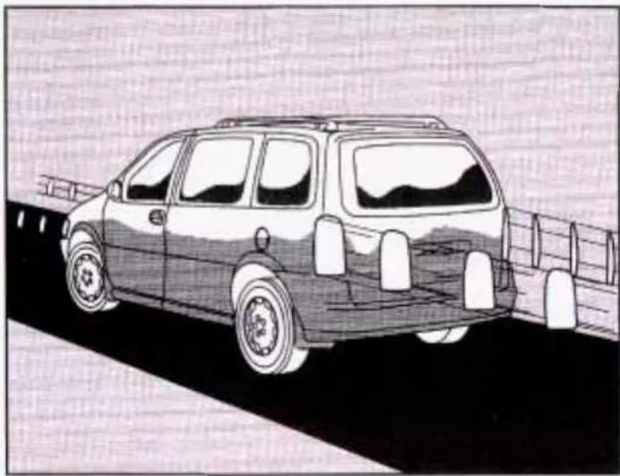 Side view of a vintage minibus parked on a road with railings (no visible text or symbols)