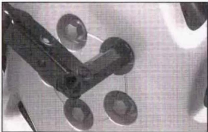 Close-up of mechanical components with circular features, possibly tools or parts, on a textured surface (no visible text or symbols)