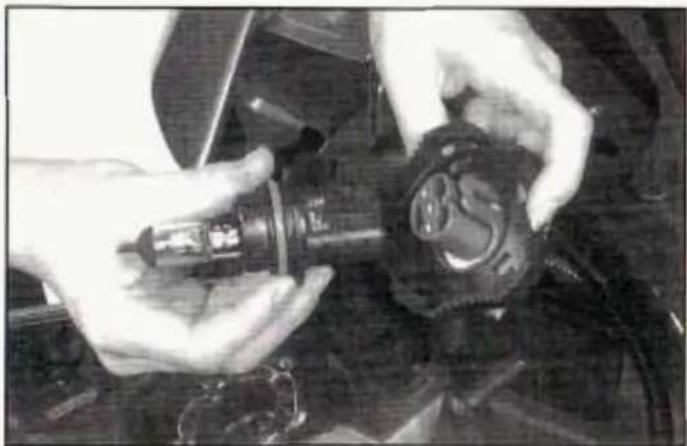 Close-up of hands assembling a mechanical component (no visible text or symbols)