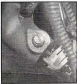 Close-up of a mechanical component with a bolt and threaded shaft (no visible text or symbols)