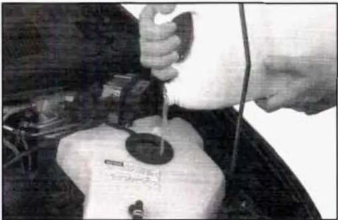 Person using a pipette to test a small object on a surface (no visible text or symbols)