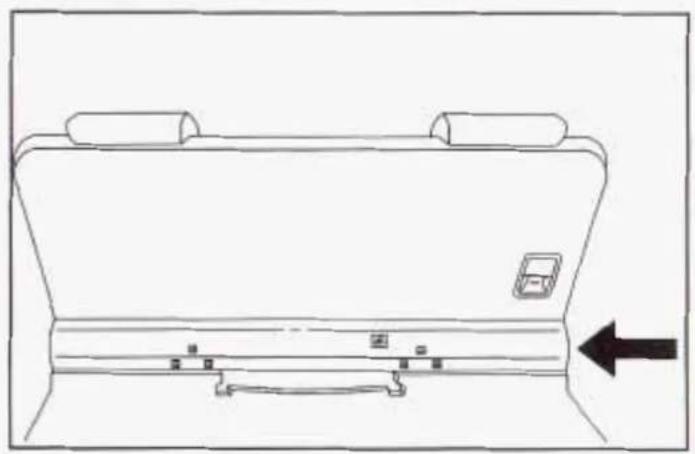 Line drawing of a vehicle rear panel with a small inset device and directional arrow (no text or symbols)