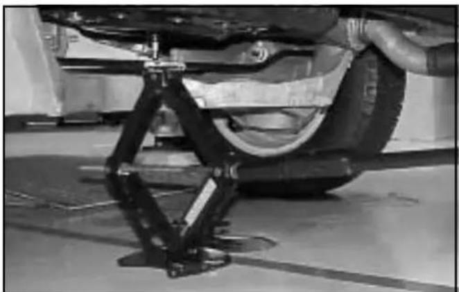 Mechanical assembly setup showing a car tire mounted on a lift with a support frame (no visible text or symbols)