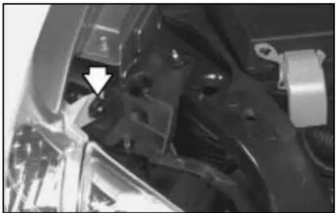 Close-up of mechanical components with a white arrow pointing to a specific part (no visible text or symbols)