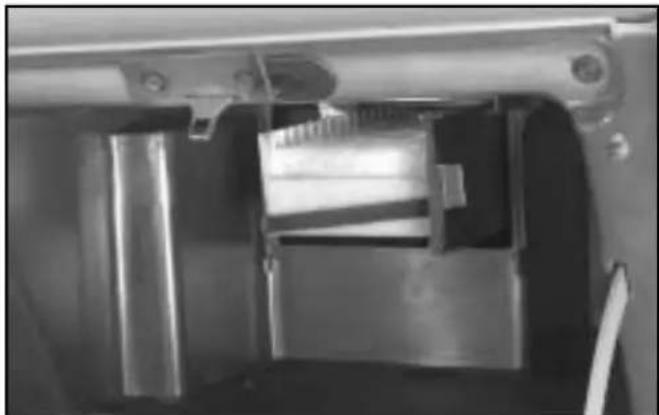 Close-up of a mechanical device with metallic components and mounting brackets (no visible text or symbols)