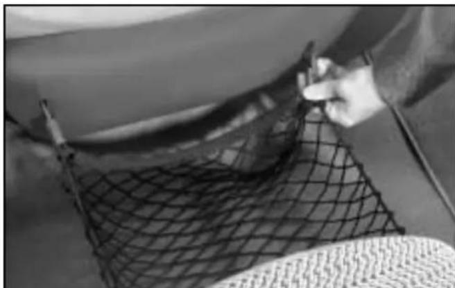 Close-up of a person handling a mesh net with a handle, no visible text or symbols