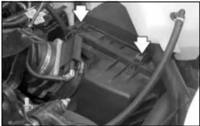 Close-up of mechanical components with white arrows pointing to features (no visible text or symbols)