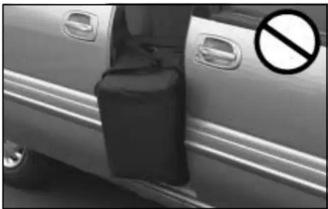 Side view of a car door with a black compartment and a no-smoking symbol (no text or numbers present)