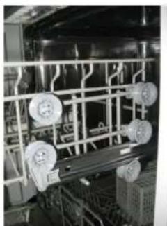 Interior view of an industrial facility with overhead piping and circular components (no visible text or symbols)