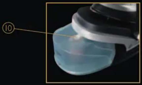 Close-up of a transparent plastic container with a metallic lid, against a black background (no text or symbols visible)