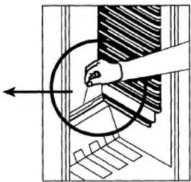 Diagram showing a hand holding a circular object over a mechanical component, with no visible text or symbols.