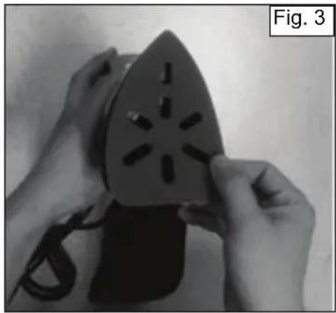 Close-up of hands using a power iron to cut a triangular socket with internal slots (no text or symbols visible)