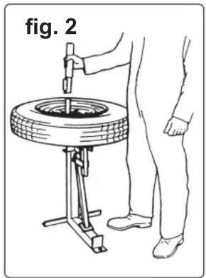 Illustration of a person using a tire presser to lift a large wheel, with no text or symbols present.