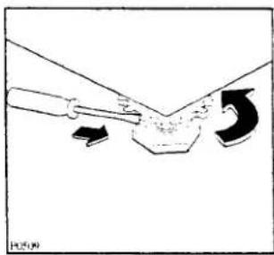 Diagram showing a tool interacting with a mechanical component, with arrows indicating motion (no text or symbols)
