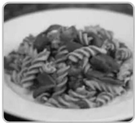 Close-up of a plated dish featuring sliced noodles and vegetables (no visible text or symbols)