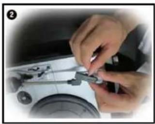 Close-up of hands assembling a small mechanical component on a white surface (no visible text or symbols)
