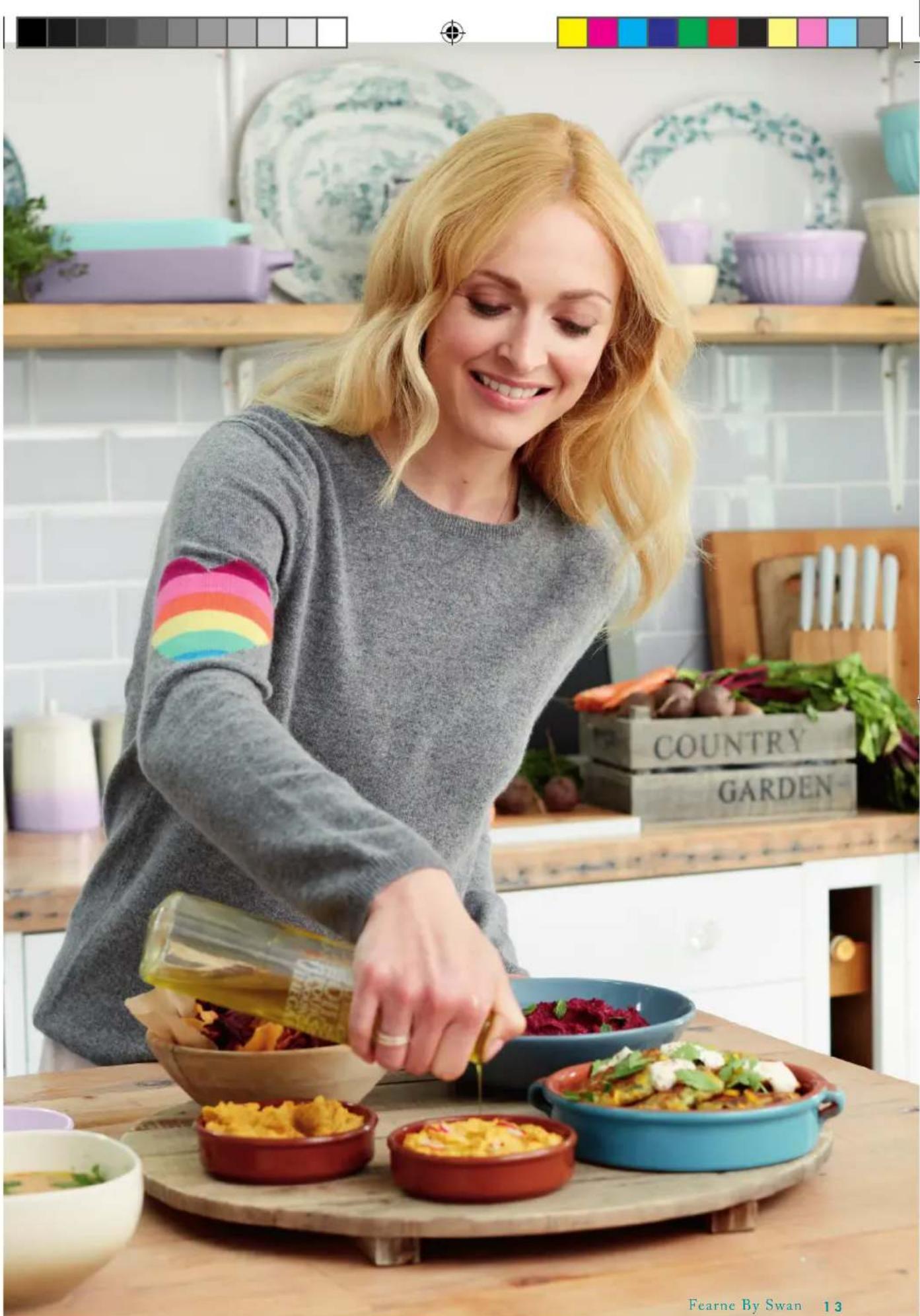 Woman preparing food in a kitchen, pouring sauce from a bottle into bowls of colorful dishes (no visible text or symbols)
