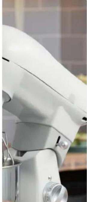 Close-up of a white kitchen mixer with handle and control panel (no visible text or symbols)