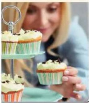 Close-up of a person holding up a cupcake stand, with no visible text or symbols.
