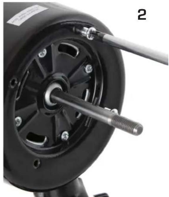 Close-up of a black mechanical component with a threaded shaft and central hub, no visible text or symbols