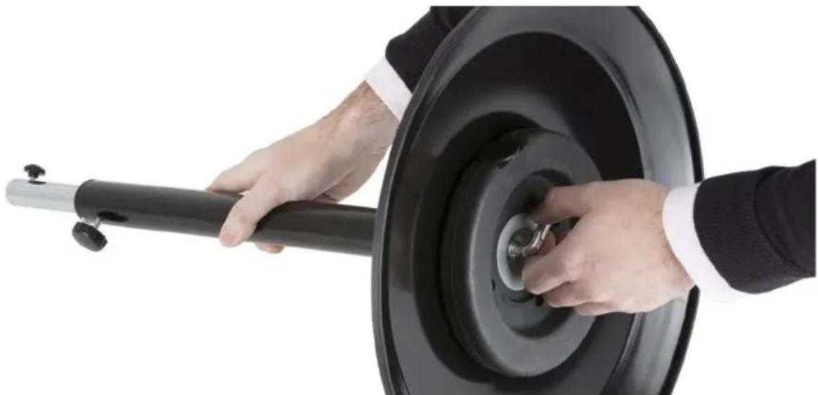 Close-up of hands adjusting a black tire with a small valve (no text or symbols visible)