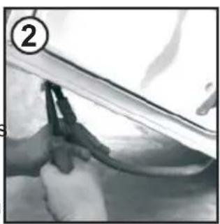 Close-up of hands using a tool to clean or repair a surface.