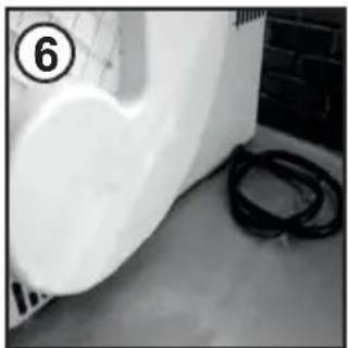 Exterior view of a white industrial pipe or container with black hoses, no visible text or symbols.