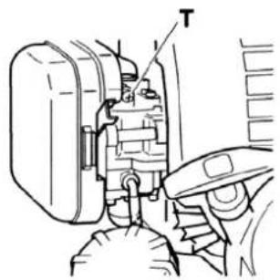 Technical diagram showing a mechanical assembly with labeled component 'T' and directional arrow indicating movement or force.