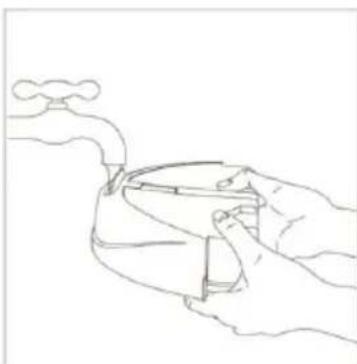 Line drawing of a hand holding a small object with a faucet above (no text or symbols).