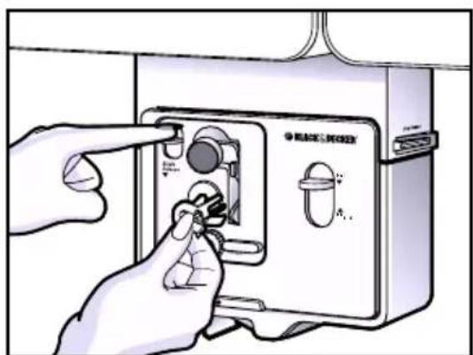 Diagram showing hands operating a device with labeled buttons and a dial indicator, likely for manual or diagnostic operation.