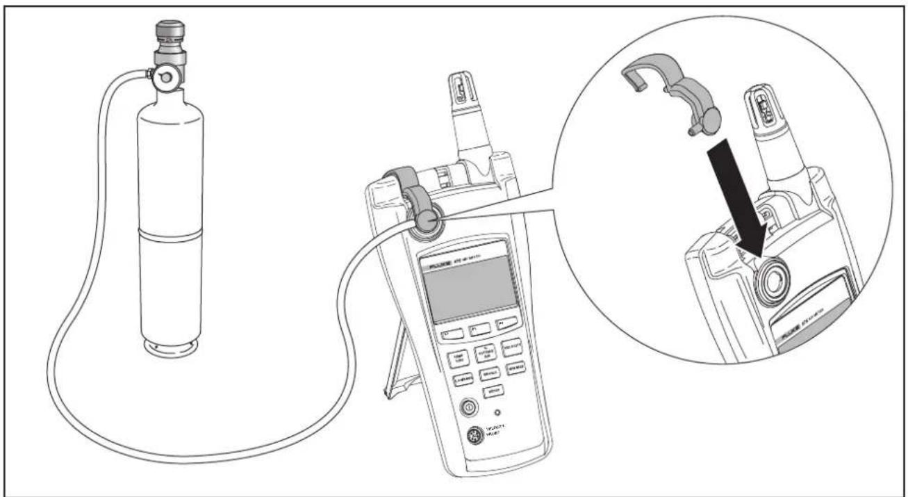 Diagram showing a gas cylinder connected to a handheld device, with an inset magnified view highlighting the device's internal structure.
