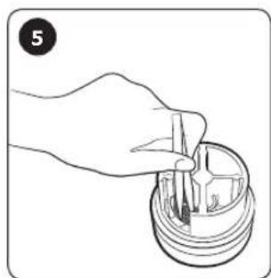 Hand holding a small mechanical component with a circular housing (no text or symbols visible)