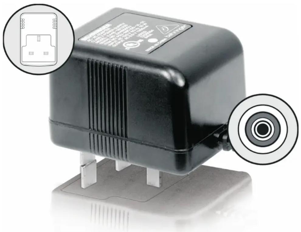 Close-up of a black industrial sensor device with labeled ports and warning symbols, including a close-up inset showing internal components.