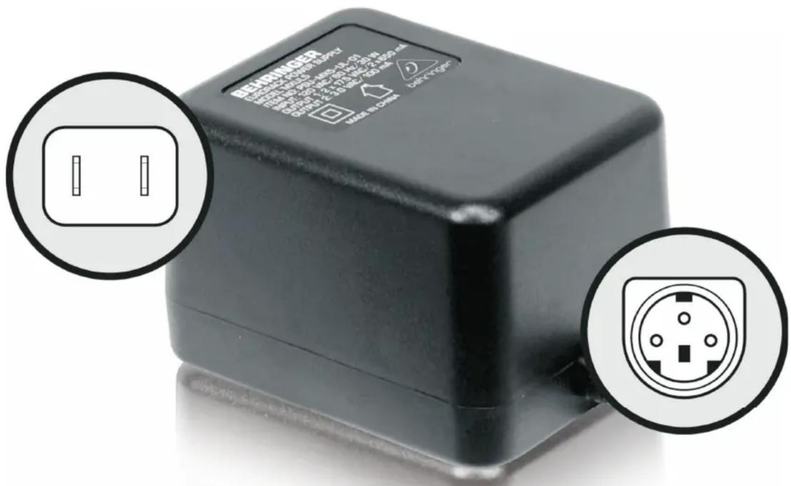 Close-up of a black electronic device with two circular annotations showing electrical socket symbols and warning labels.