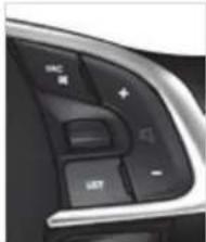 Close-up of a car dashboard with control buttons and a play button (no visible text or symbols)