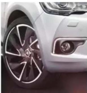 Close-up of a white car wheel rim and dashboard (no visible text or symbols)