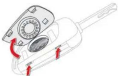 Diagram of a handheld device with a circular component and red directional arrows indicating rotation or movement (no text or symbols)