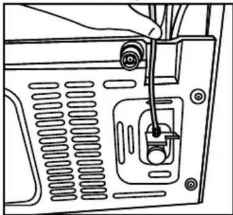 Line drawing of a computer monitor rear panel with a hand inserted, showing no text or symbols