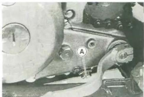 Close-up mechanical component with labeled parts (A) and circular indicators, no readable text or symbols beyond labels