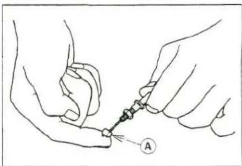 Line drawing of two hands holding a small object with a pointer and label 'A' (no text or symbols on the object itself)