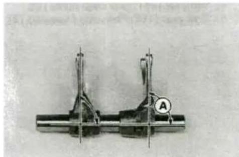 Mechanical component with two vertical posts and a circular symbol labeled 'A' (no readable text or symbols beyond the label)