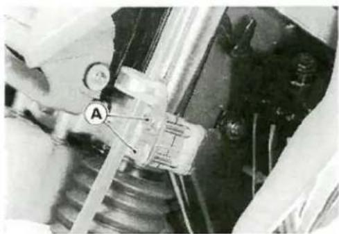 Mechanical assembly diagram showing a component labeled 'A' connected to a spring and housing (no readable text or symbols)