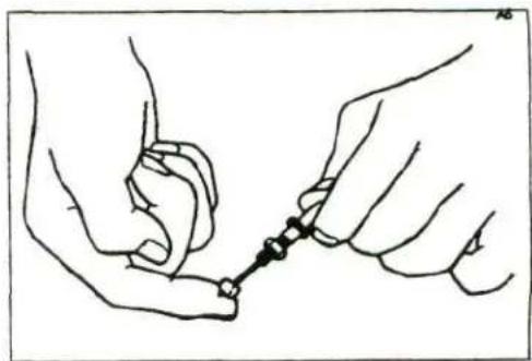 Line drawing of two hands tying a knot around a small object (no text or symbols)