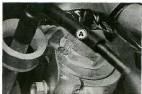Close-up of mechanical components with a tool and labeled component A (no readable text or symbols)